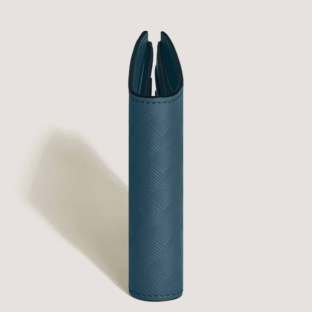 A Montblanc Extreme 3.0 6cc Leather Wallet, displayed upright against a light backdrop, exudes the elegance reminiscent of a Montblanc emblem. Its textured pattern adds intrigue as shadows fall to the left, and its partially open design reveals a dark interior—ideal for modern urban explorers in search of style and function.