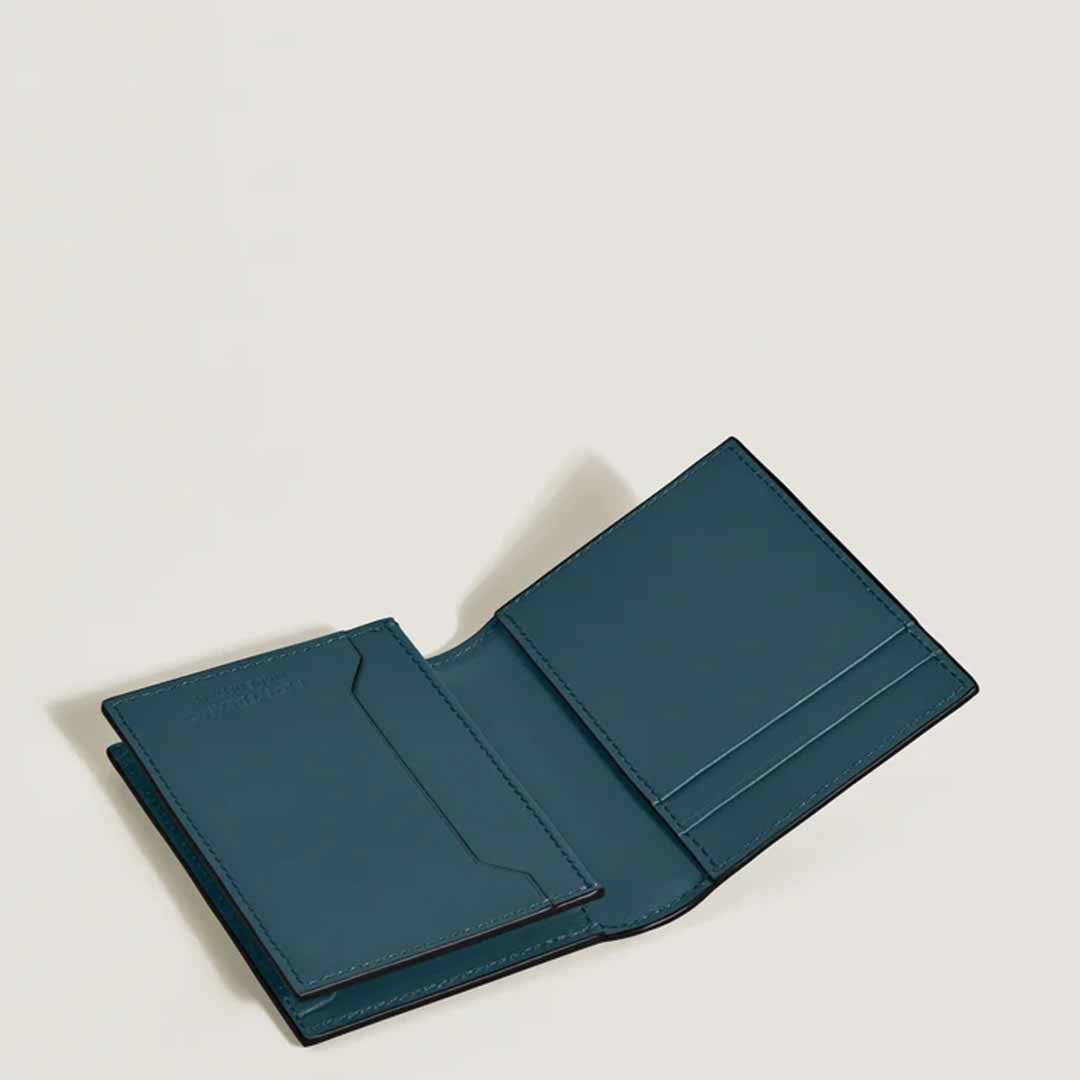 Open Montblanc Extreme 3.0 4cc Leather Card Holder in dark green, featuring multiple card slots and adorned with the Montblanc motif, placed on a light beige background.