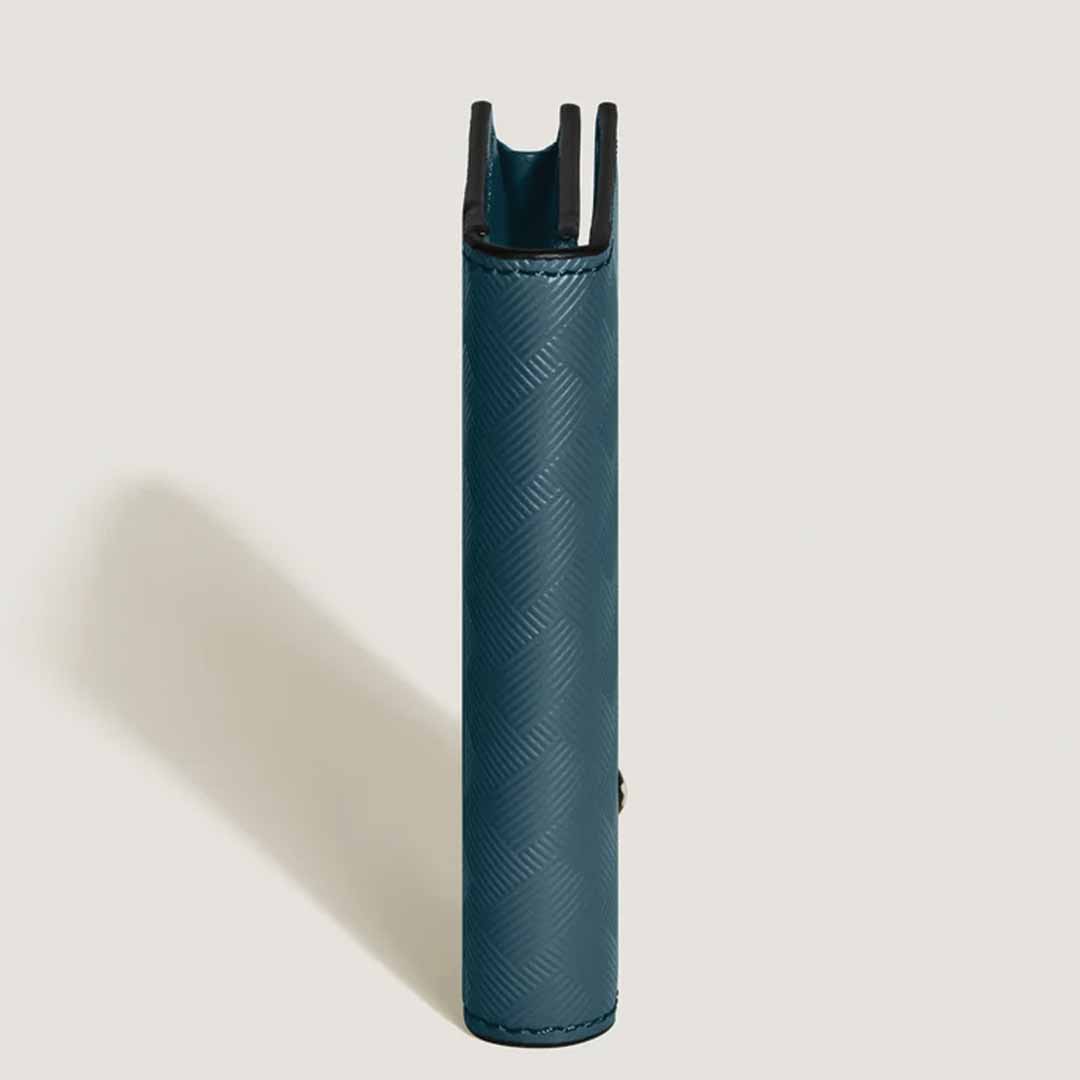 A side view of a teal, textured leather case with the Montblanc Extreme 3.0 motif stands upright against a plain background. This case, akin to the Montblanc Extreme 3.0 4cc Leather Card Holder, showcases a vertical opening at the top.