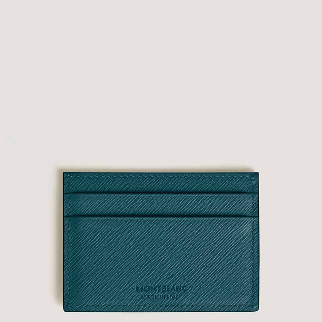 The Montblanc Sartorial 4cc Leather Card Holder is crafted from green Saffiano-printed leather and features multiple slots. It is elegantly displayed against a plain, light background, showcasing the iconic Montblanc emblem embossed at the bottom center, symbolizing elegance and style.