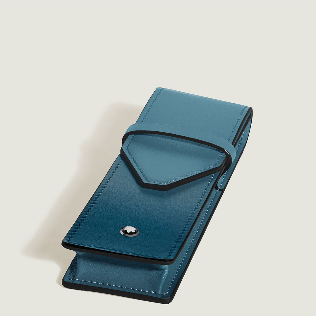 The Montblanc Meisterstuck Leather Double Pen Pouch features teal sfumato leather, a flap closure with black edging, and a metallic button—ideal for your Meisterstück Classique or LeGrand—shown against a plain light backdrop.