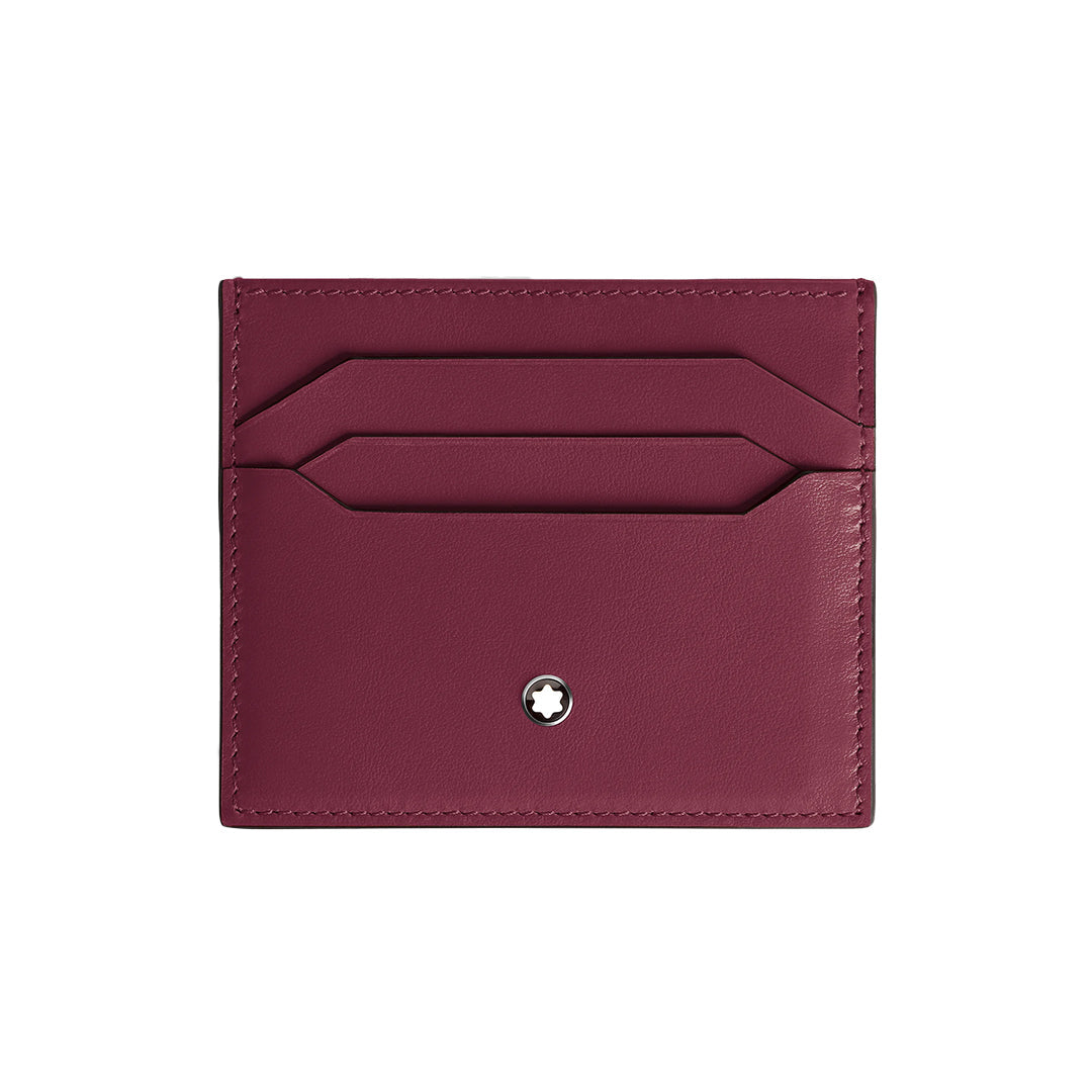 The Montblanc Meisterstück 6CC Card Holder, made of burgundy cassis deep shine leather, includes two slots for six credit cards. A small circular metal emblem with a white star embellishes the bottom center, and precise stitching enhances its elegance.