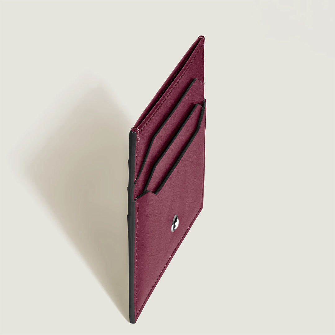 Angled view of the Montblanc Meisterstück 6CC Card Holder in cassis deep shine leather with two card slots and a snap button closure, perfect for holding six credit cards, set against a plain, light background.