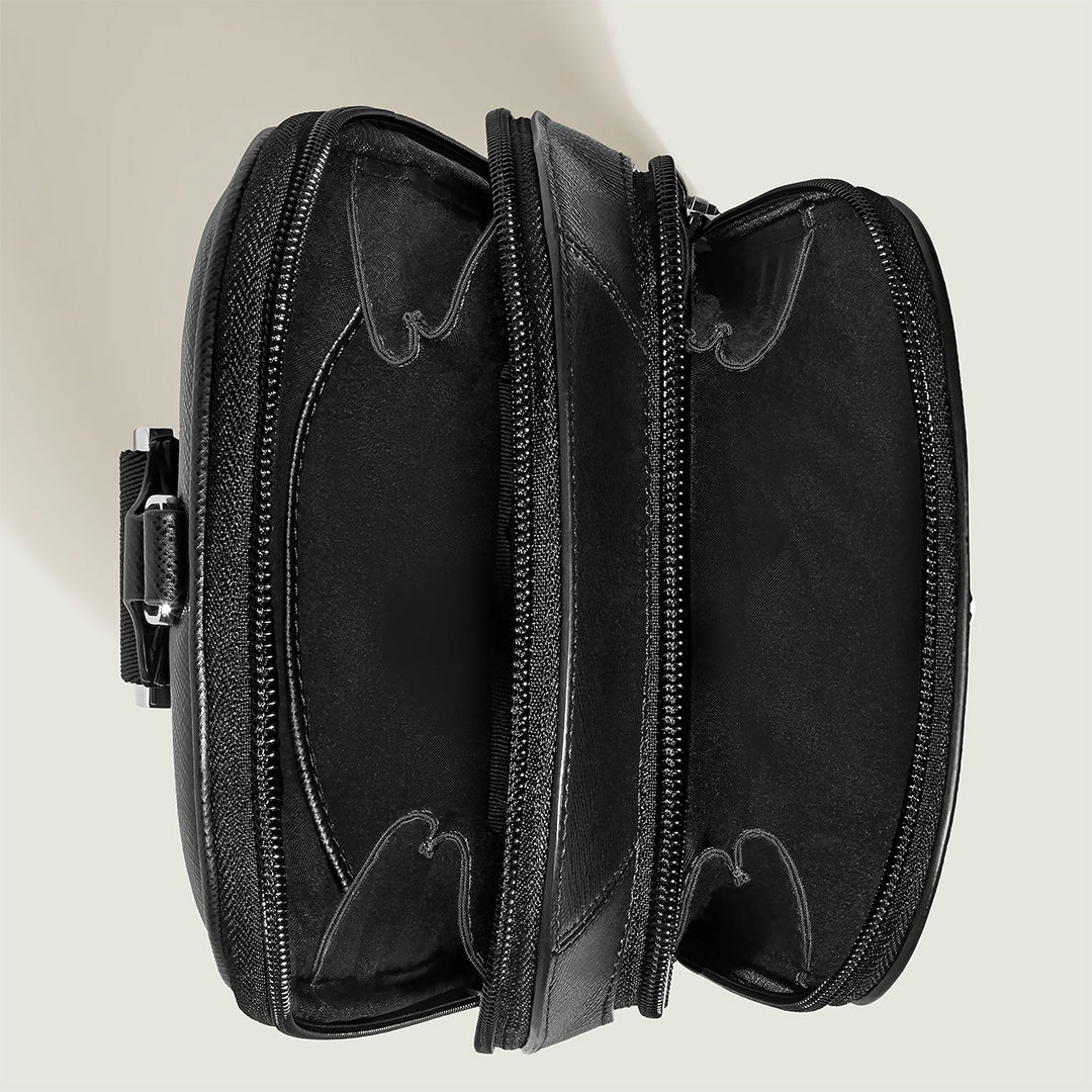 The top view image shows an open Montblanc Sartorial Sling Bag in black saffiano-embossed leather, featuring multiple compartments and zippers against a light background.