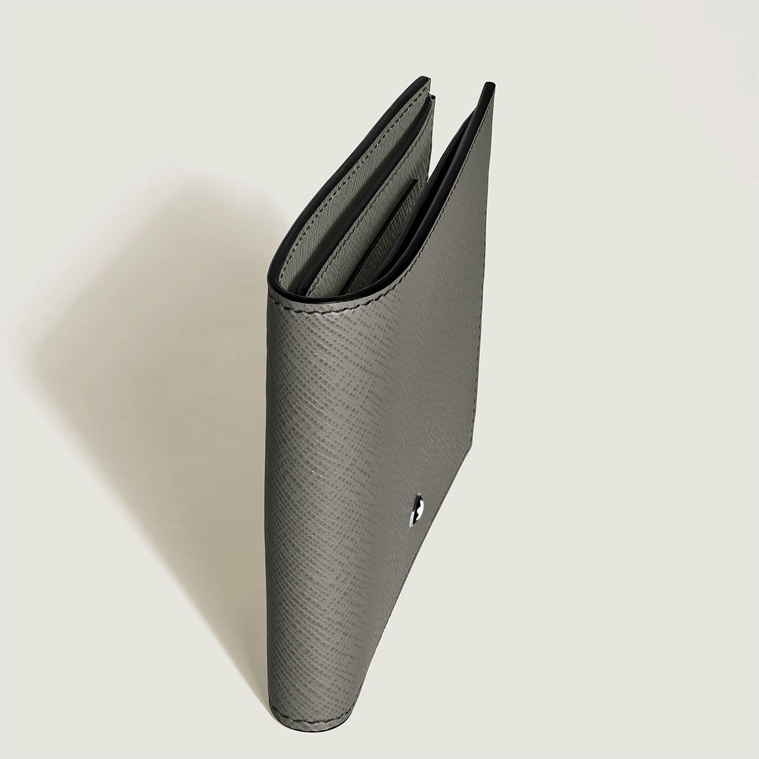 The Montblanc Sartorial 8CC Leather Wallet is shown partially open from above on a light background, revealing its compact grey Saffiano-printed bi-fold design with a metallic circular logo and organized credit card slots inside.