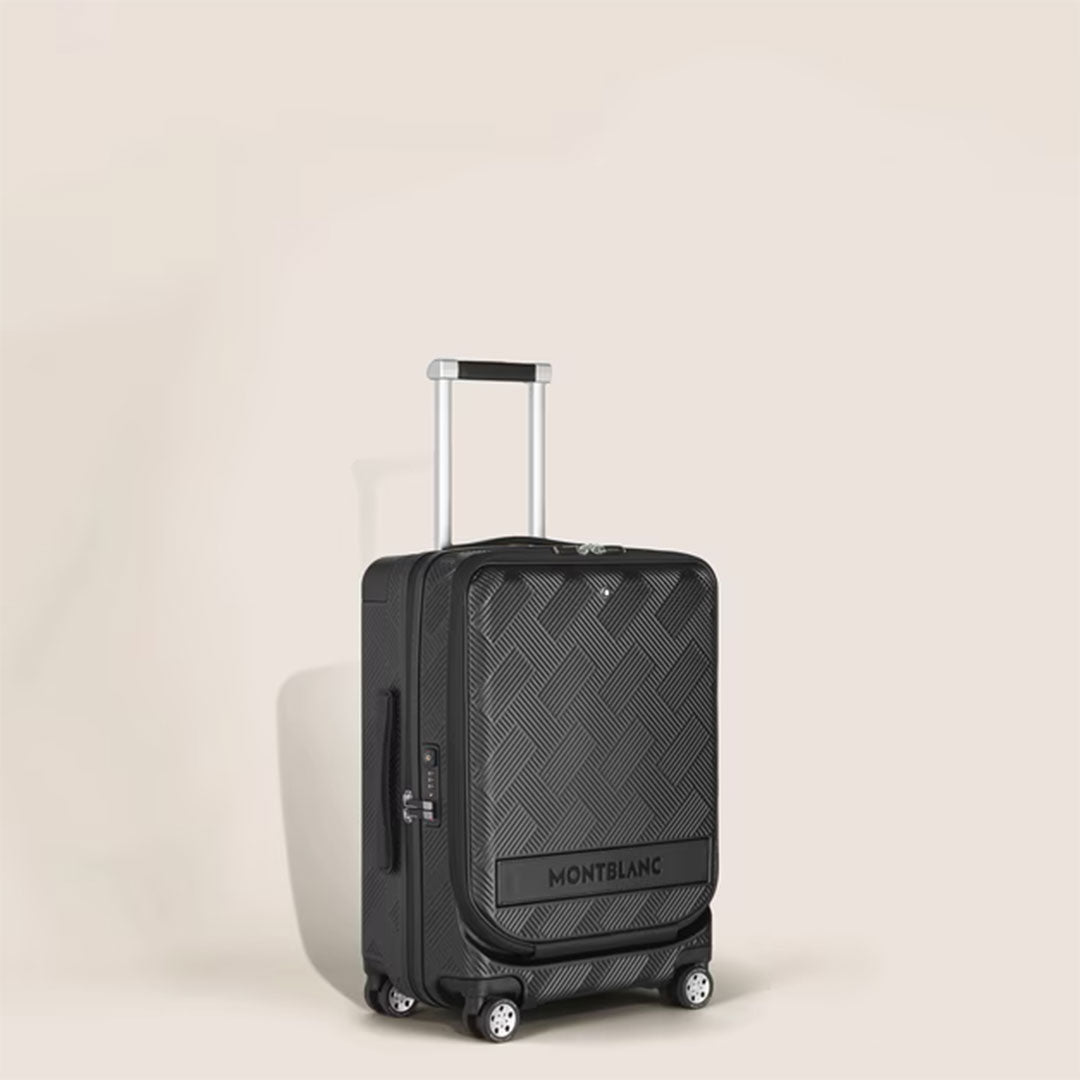 A Montblanc Extreme 3.0 Cabin with Pocket, a black polycarbonate trolley bag featuring a textured geometric pattern, telescopic handle, four wheels, and TSA lock, stands upright against a plain light background.