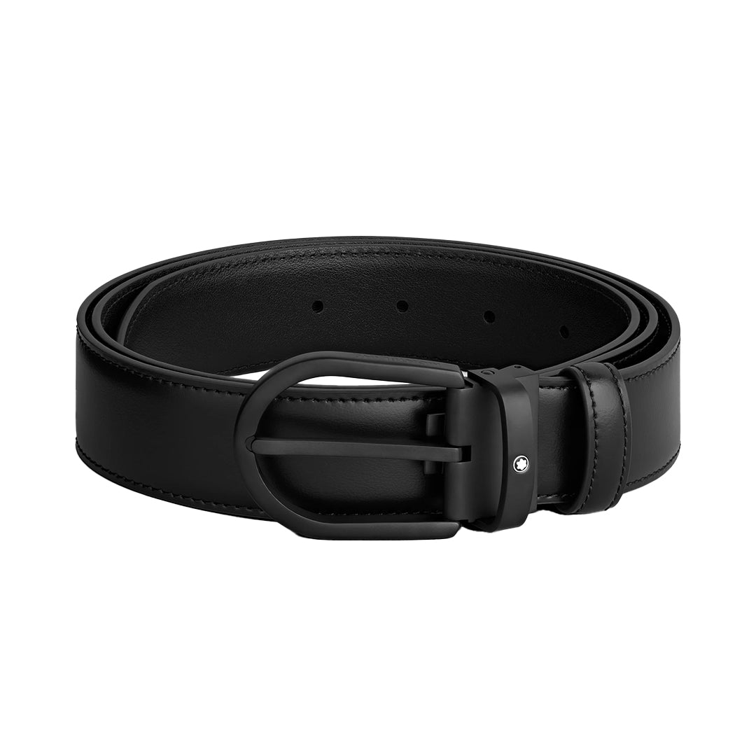 The Montblanc Horseshoe Buckle 35mm Black Leather Belt, by Montblanc, neatly coiled on a white background, features a matte black PVD buckle and smooth edges for a sleek, polished look.