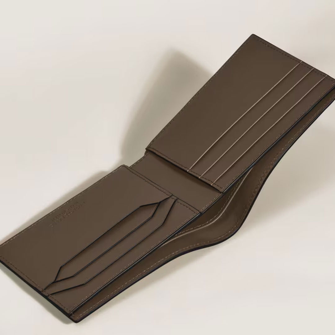 The Montblanc Extreme 3.0 6CC Leather Wallet in brown is open, revealing multiple card slots and compartments with the elegant Extreme 3.0 motif on a light background.