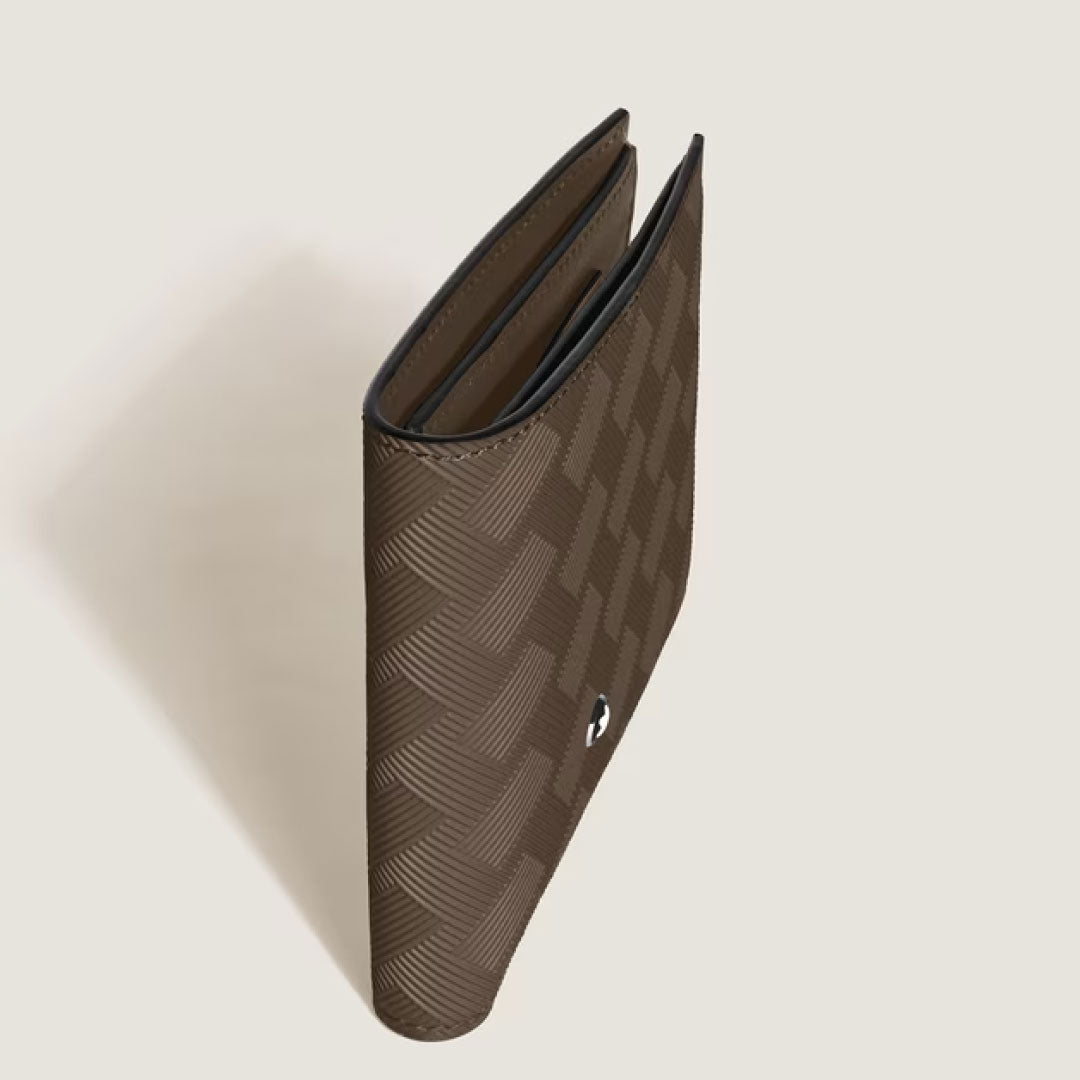 The Montblanc Extreme 3.0 6CC Leather Wallet, crafted in rich brown leather with a textured geometric motif, stands partially open on a light beige background.
