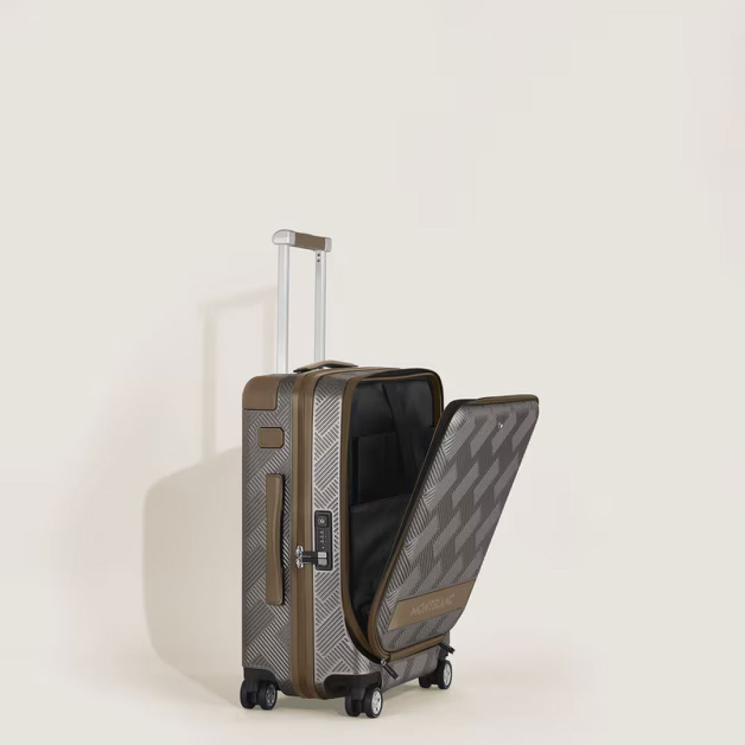 The Montblanc Extreme 3.0 Cabin Luggage with Pocket is a brown polycarbonate trolley bag featuring a patterned design, standing upright on four wheels with an extended telescopic handle and a partially open front compartment showing storage space.