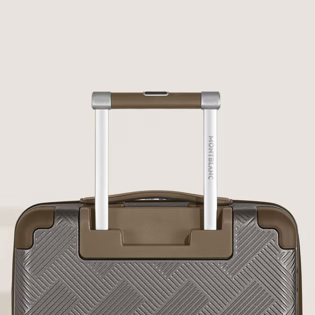 Close-up of the Montblanc Extreme 3.0 Cabin Luggage with Pocket, a brown polycarbonate trolley suitcase featuring a textured surface and an extended silver and brown telescopic handle stamped with the Montblanc logo.