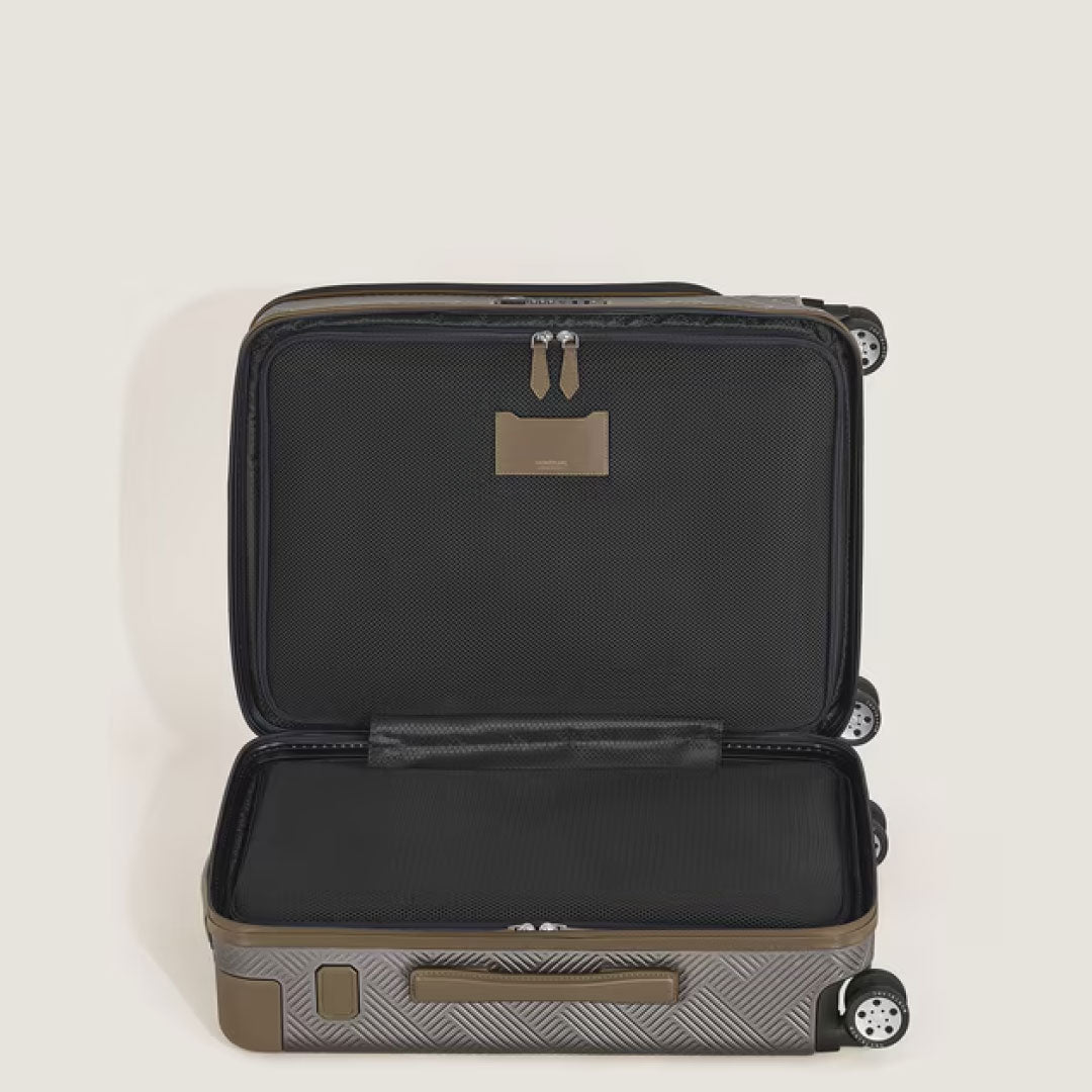 The Montblanc Extreme 3.0 Cabin Luggage with Pocket by Montblanc features a geometric pattern, a spacious black interior with zippered compartment, four wheels, and a TSA lock, all set against a plain light background.