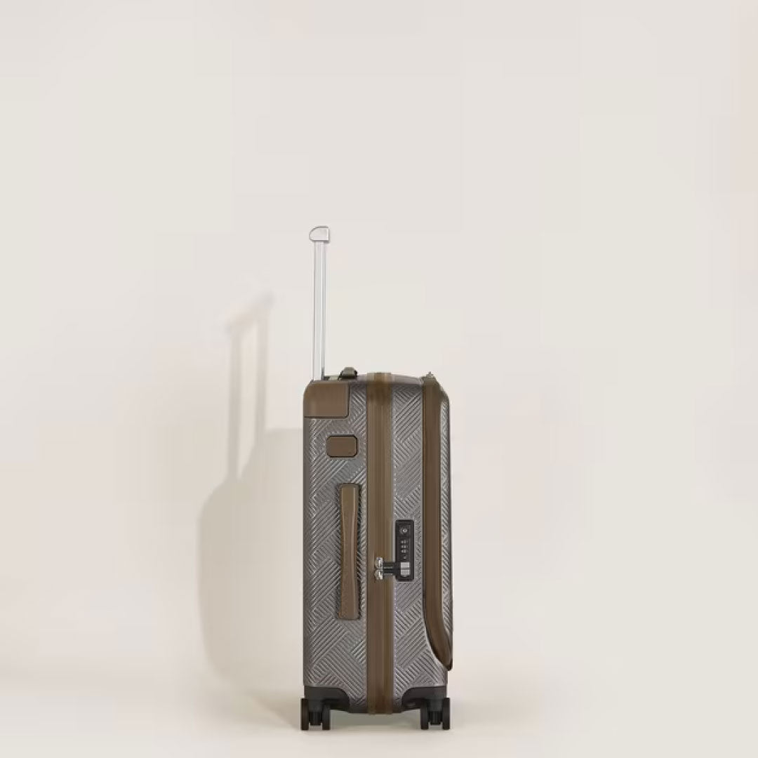 The Montblanc Extreme 3.0 Cabin Luggage with Pocket, a brown patterned polycarbonate trolley by Montblanc, stands upright on four wheels with its telescopic handle extended against a light background.