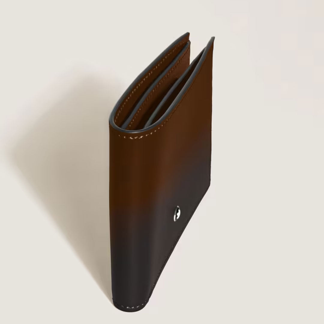 The Montblanc Meisterstuck Sfumato 6CC Leather Wallet in rich brown stands upright, highlighting its stitched edges and a small metal accent—a refined luxury piece from Montblanc.