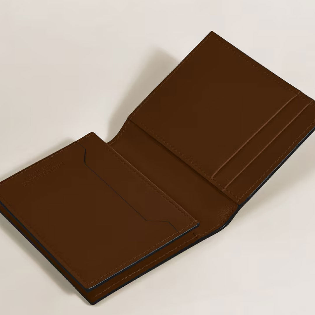 A Montblanc Meisterstück 4cc Brown Sfumato Leather Card Holder by Montblanc is open on a light surface, displaying organized card slots and compartments for bills.