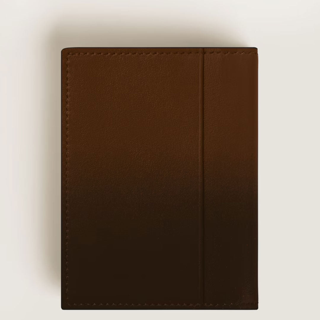 A Montblanc Meisterstuck 4cc Brown Sfumato Leather Card Holder lies flat on a light surface, its dark brown leather and refined Montblanc craftsmanship captured from above.