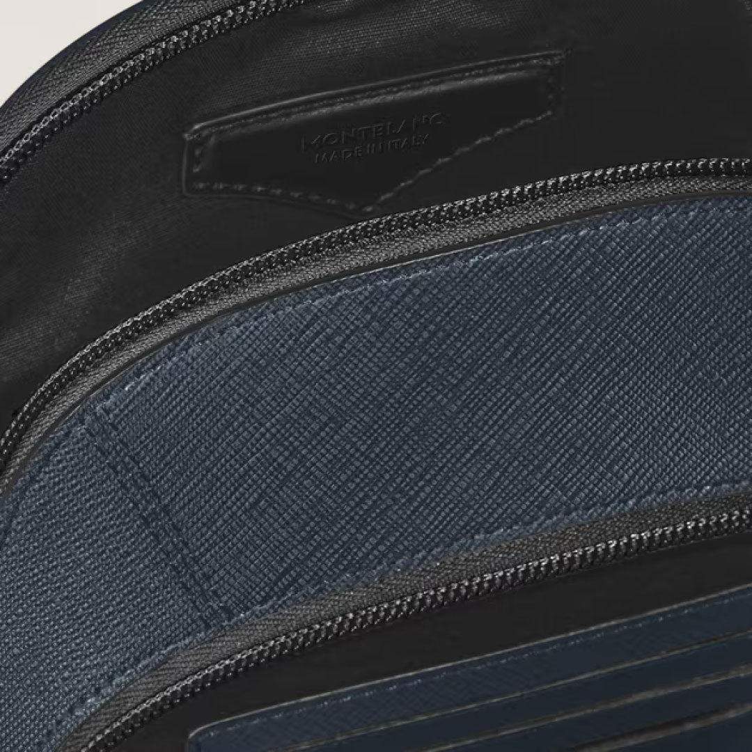 Close-up of the Montblanc Sartorial Leather Sling Bag’s interior, highlighting its dark blue leather, visible stitching, zippered compartment, and an interior Montblanc-embossed leather tag.