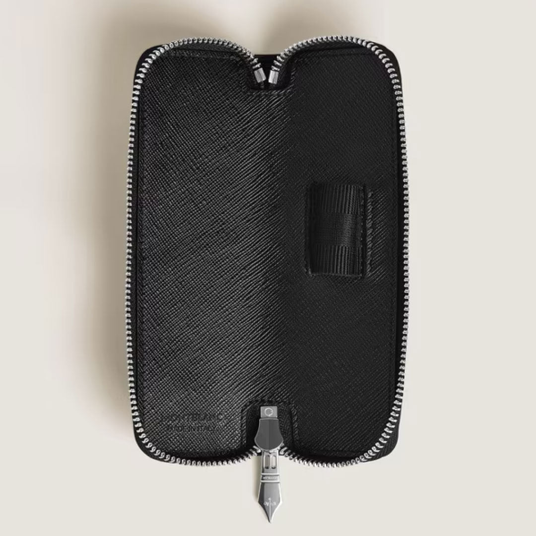 The Montblanc Sartorial Single Leather Pen Pouch With Zip is shown open, revealing an empty interior with a small elastic strap. The black case features textured sartorial leather, a silver zipper, and is crafted by Montblanc.