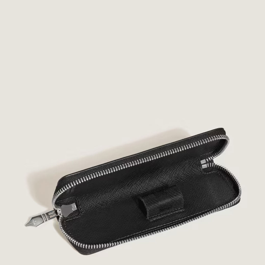 The Montblanc Sartorial Leather 2 Pen Pouche With Zip features textured black leather, a pen loop, and smooth lining—an elegant writing instrument holder, displayed against a plain light background.