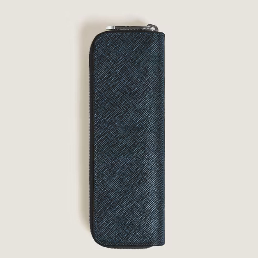 The Montblanc Sartorial Blue Single Leather Pen Pouch with Zip features textured navy leather and rounded edges, standing vertically to offer style and practicality for your favorite writing tools.