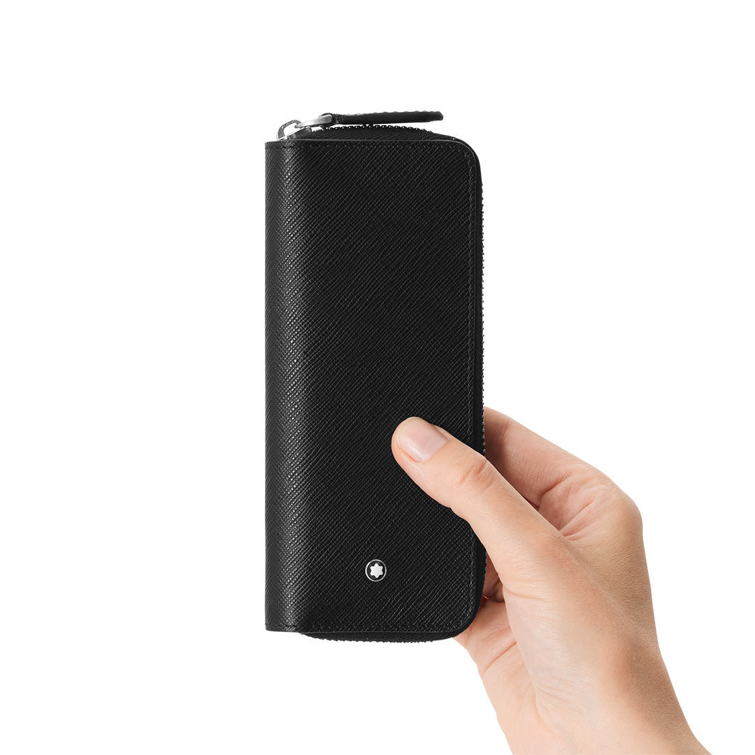 A hand holds a Montblanc Sartorial Black 2-Pen Pouch with Zip upright against a plain white background.