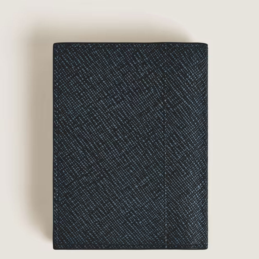 The Montblanc Sartorial Leather 4cc Card Holder, a closed rectangular piece in dark blue textured leather, is shown against a light background from a top-down view.