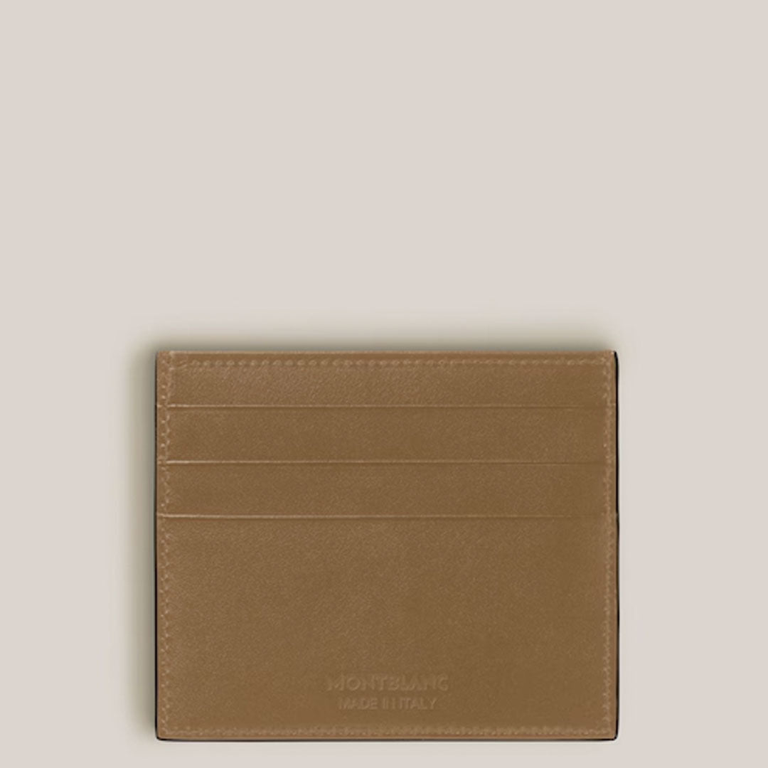 The Montblanc Meisterstuck 6CC Leather Card Holder in tan leather with four card slots is shown against a light beige background, featuring "Montblanc Made in Italy" embossed on the lower right corner.