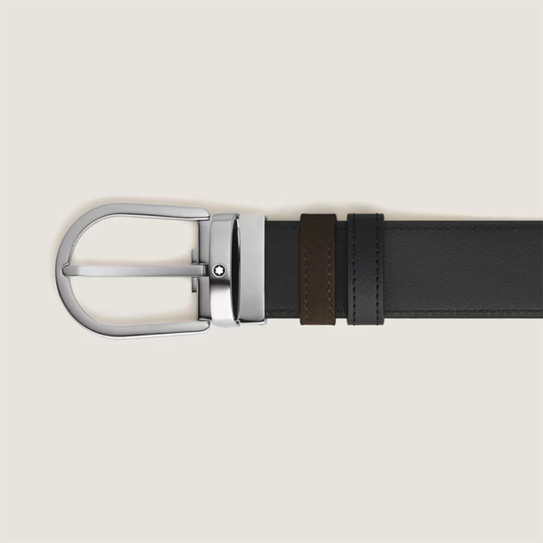 The Montblanc Horseshoe Buckle Brown and Black 35mm Reversible Leather Belt features a shiny silver buckle, black and brown loops, and is shown on a light beige background.