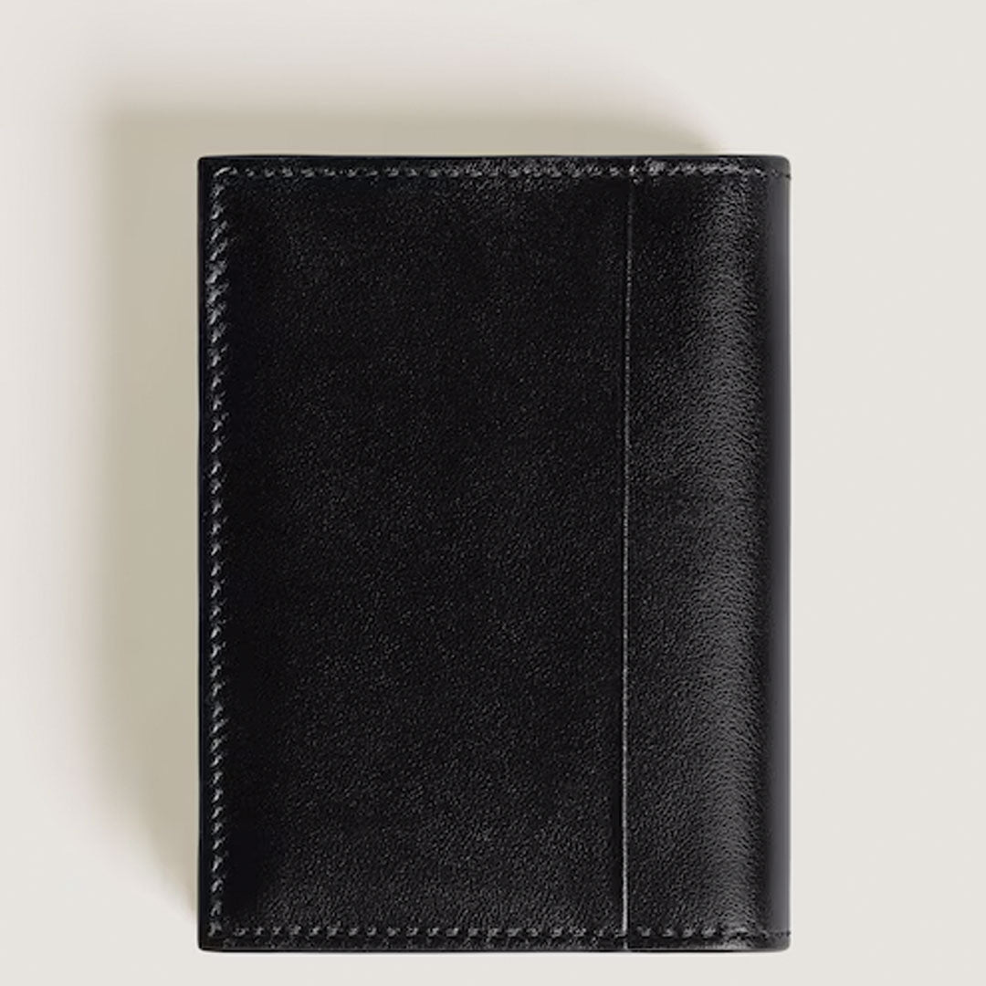 The Montblanc Meisterstuck 4CC Leather Card Holder by Montblanc is a closed, smooth black leather card holder with visible stitching and handy credit card slots, shown against a light-colored background.