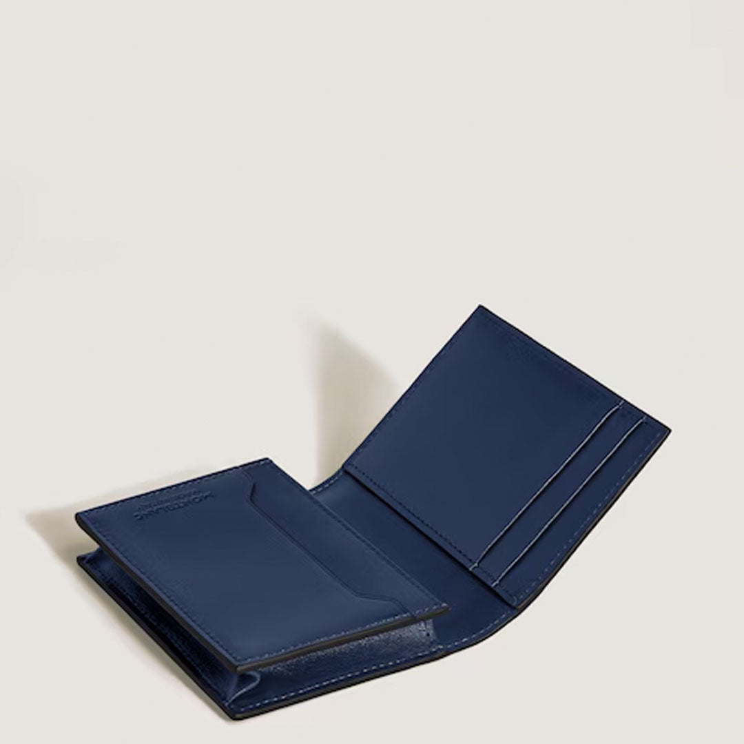 The Montblanc Meisterstuck 4CC Leather Card Holder by Montblanc, shown open against a neutral background, displays its credit card slots, bill compartment, refined interior stitching, and sleek dark blue leather design.