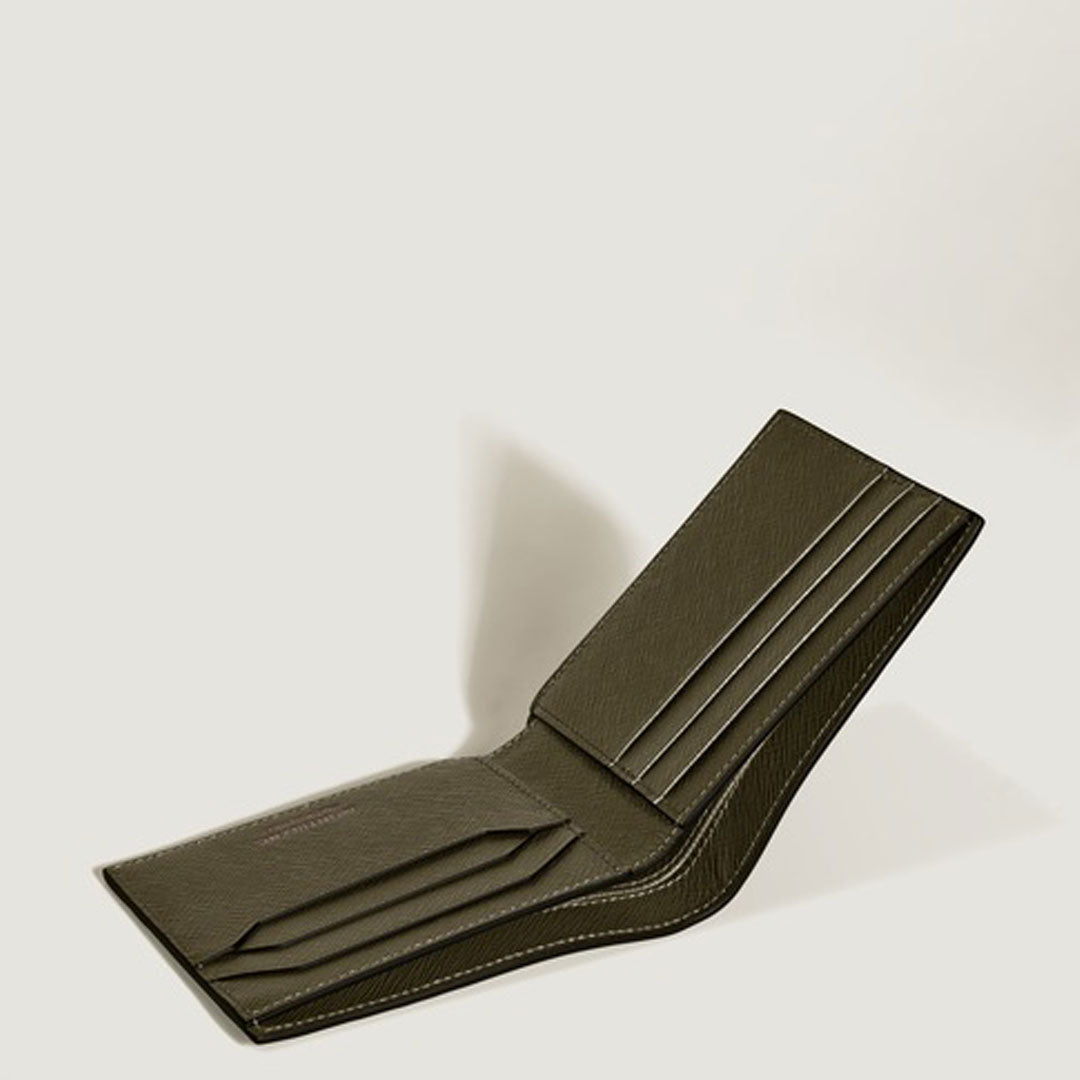 A Montblanc Sartorial 6CC Leather Wallet in dark green stands open on a light surface, displaying multiple card slots and stitched edges, with a shadow cast to the left.