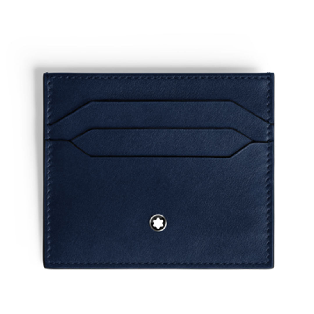 The Montblanc Meisterstuck 6CC Leather Card Holder in navy blue features two card slots, visible edge stitching, and a white circular Montblanc emblem at the lower center, set against a plain white background.