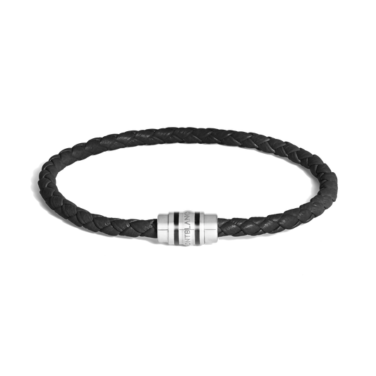 The Montblanc 3 Rings Black Grain Leather Bracelet features a black grain leather band and a silver cylindrical clasp with the Montblanc logo, shown elegantly on a white background.