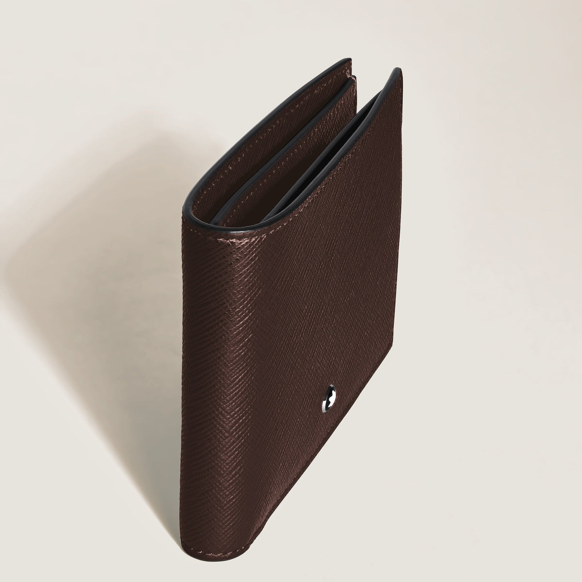 A Montblanc Sartorial 6CC Leather Wallet stands partly open on a light surface, viewed from above at an angle.