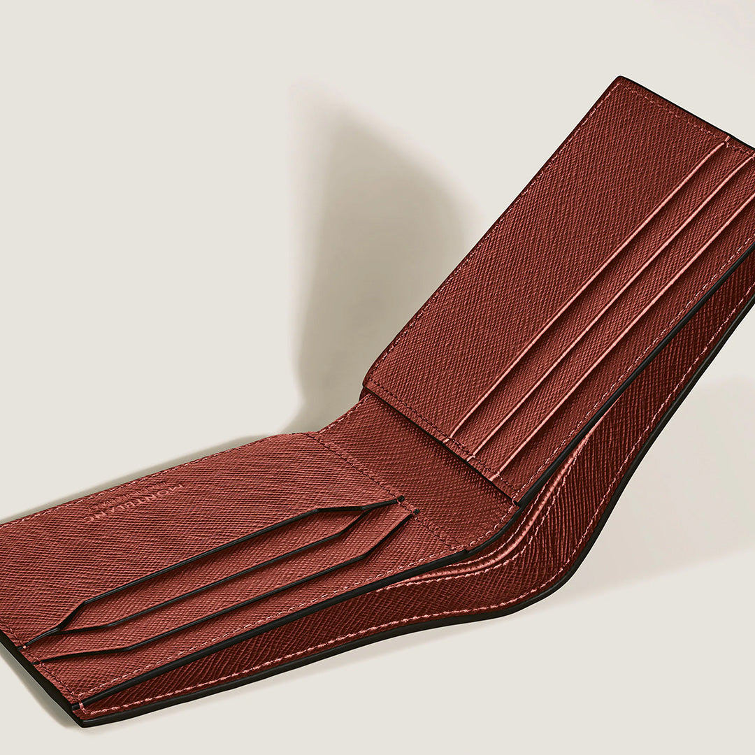 A Montblanc Sartorial 6CC Leather Wallet in brown is displayed open and at an angle on a simple light background. Crafted from textured, Sartorial-embossed leather, the wallet showcases multiple card slots and visible edge stitching.