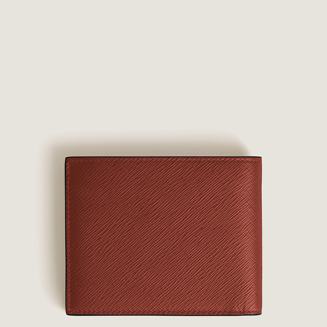 A closed Montblanc Sartorial 6CC Leather Wallet in textured brown, featuring the brand’s signature embossed leather, is centered on a plain, light background.