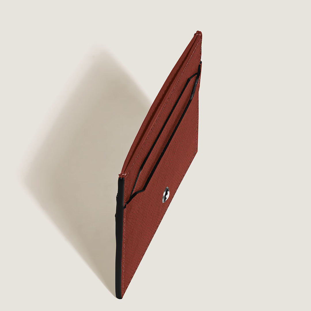 A slim, brown textured embossed leather envelope clutch with a snap button closure is displayed from an angled top view against a plain light background—an elegant accessory that complements the Montblanc Sartorial 5CC Leather Card Holder by Montblanc.
