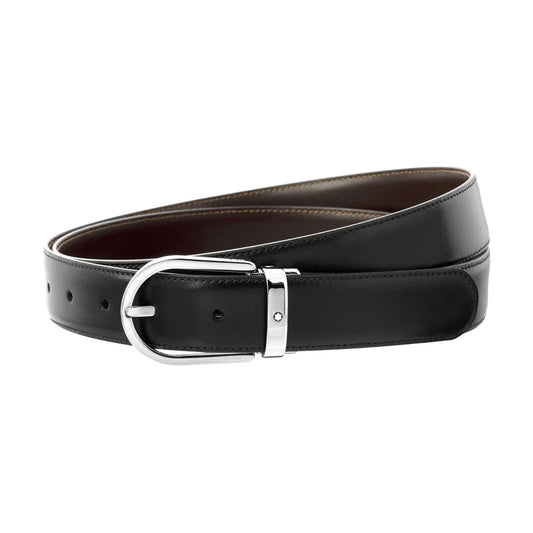 The Montblanc Classic Line Reversible Black/Brown Leather Belt, coiled neatly, features a shiny silver buckle and multiple holes for the perfect fit. This sleek and polished design by Montblanc is ideal for both formal and casual occasions.