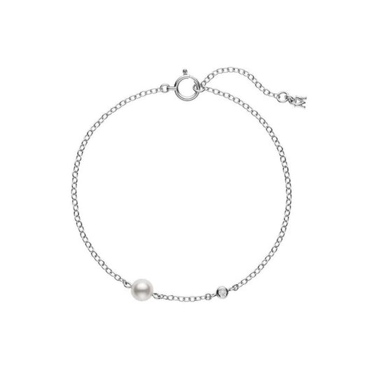 The Mikimoto 18K White Gold Diamond and Akoya Cultured Pearl Station Bracelet is a simple and elegant piece, featuring a delicate 18K white gold chain adorned with an Akoya cultured pearl and a small round gemstone. The bracelet includes an adjustable clasp with a charming end detail.