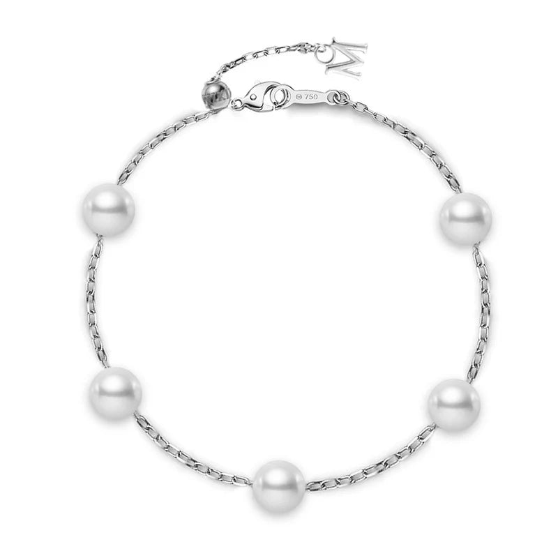 The Mikimoto 18K White Gold Akoya Cultured Pearl Station Bracelet features five evenly spaced round Akoya cultured pearls set on a delicate 18K white gold chain, finished with an adjustable clasp and a petite dangling charm.