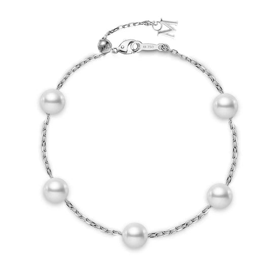 The Mikimoto 18K White Gold Akoya Cultured Pearl Station Bracelet features five evenly spaced round Akoya cultured pearls set on a delicate 18K white gold chain, finished with an adjustable clasp and a petite dangling charm.