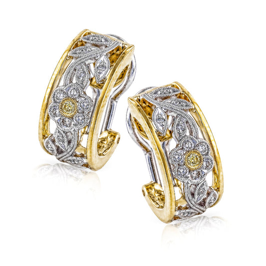 The Simon G. 18K Yellow and White Gold Diamond Hoop Earrings from Simon G feature a vintage-inspired style with intricate floral designs adorned with white and yellow diamonds, expertly set in both yellow and white gold. The detailed openwork pattern exquisitely showcases flowers and leaves, epitomizing elegance and sophistication.