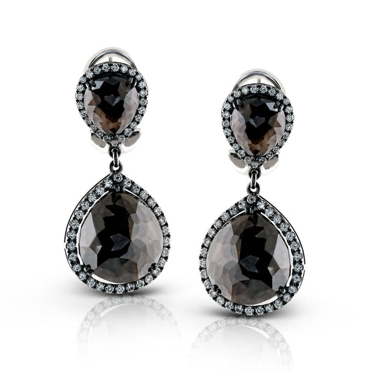 These Simon G. 18K White Gold Diamond Earrings exhibit an elegant teardrop design with large, faceted black stones encircled by small clear gems. The double-tier structure accentuates the main teardrop shape with matching smaller stones positioned above, offering a stunning complement to any look.