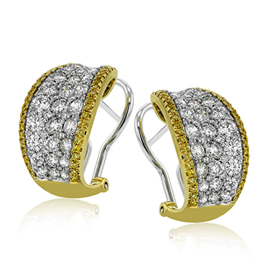The Simon G. 18K White and Yellow Gold Diamond Hoop Earrings by Simon G present a sophisticated two-tone design in gold and silver. Adorned with dazzling white diamonds, these earrings boast an intricate pattern and are equipped with a convenient clip-on fastening mechanism.