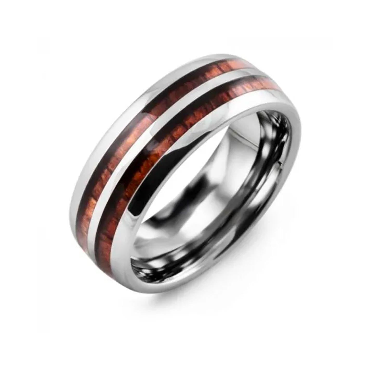 Introducing the Madani Tungsten And Koa Wood Wedding Band: a polished silver ring featuring two parallel inlays of Koa wood, each exhibiting a rich, dark brown hue. Its shiny and smooth finish echoes the sophistication and modern style of a classic Tungsten wedding band, all beautifully captured against a white background.