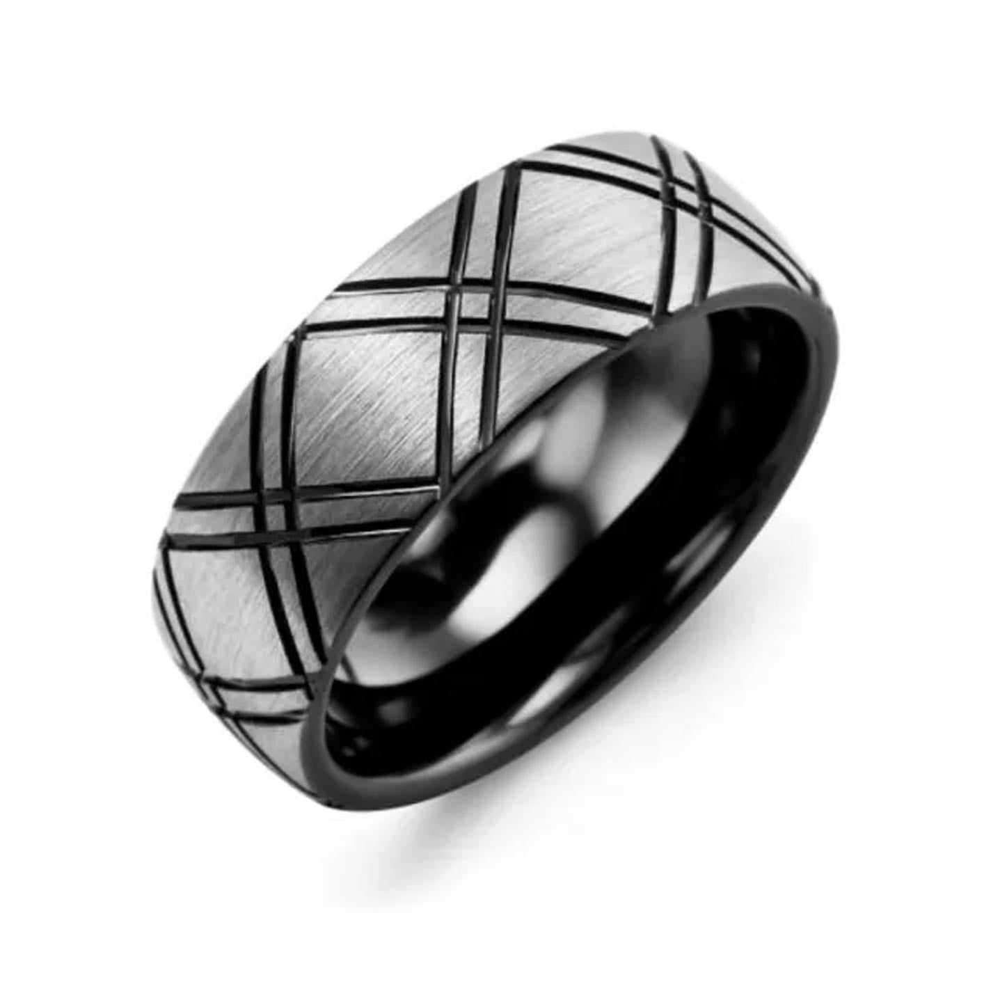 The Madani Dome Carved Line Tungsten Wedding Band, by Madani, features a matte silver finish with a crisscross pattern and a glossy black inner band. This 8mm band's sleek design makes it perfect for any occasion.