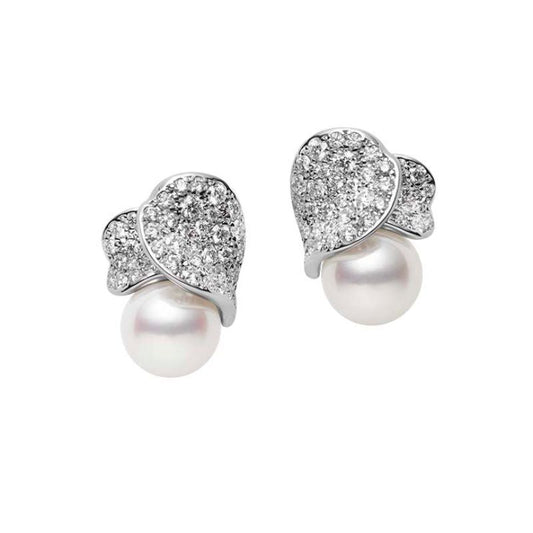 Introducing the Mikimoto 18K White Gold Les Pétales Place Vendôme earrings, where luxurious Akoya cultured pearls are elegantly set beneath exquisite, leaf-shaped designs. These intricate pieces are adorned with sparkling diamonds, reflecting both luxury and craftsmanship from the renowned brand Mikimoto.