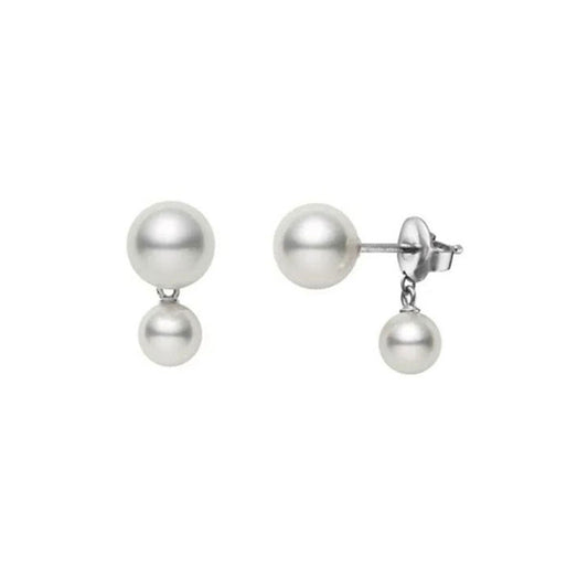 These sophisticated Mikimoto earrings, bearing the name "Mikimoto 18K White Gold Pearl Earrings with Jackets," showcase a stunning design featuring two Akoya pearls: a larger one sits atop while a smaller pearl dangles below, all elegantly set on 18K white gold studs.