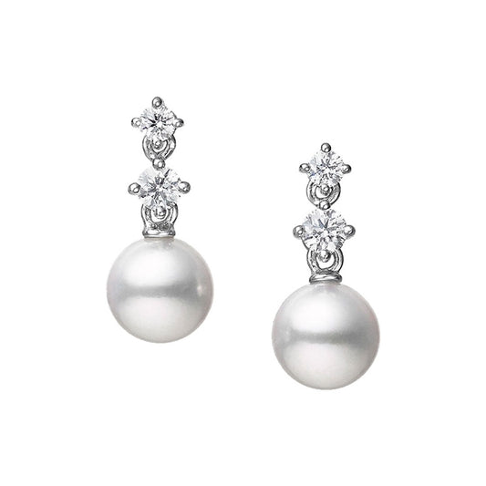 Elevate your look with the Mikimoto Morning Dew Drop Earrings. These earrings from Mikimoto showcase a stunning Akoya cultured pearl at the base, accentuated by two small round diamonds elegantly stacked above, all set in radiant 18K white gold against a simple white background.