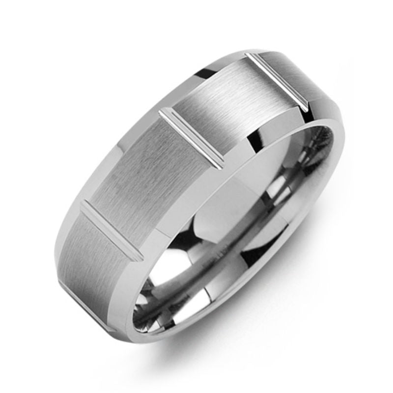 The Madani Beveled Brushed Grooved Tungsten Wedding Band serves as a sophisticated silver tungsten ring, featuring a satin finish with sleek vertical grooves and elegant rectangular patterns encircling the band.